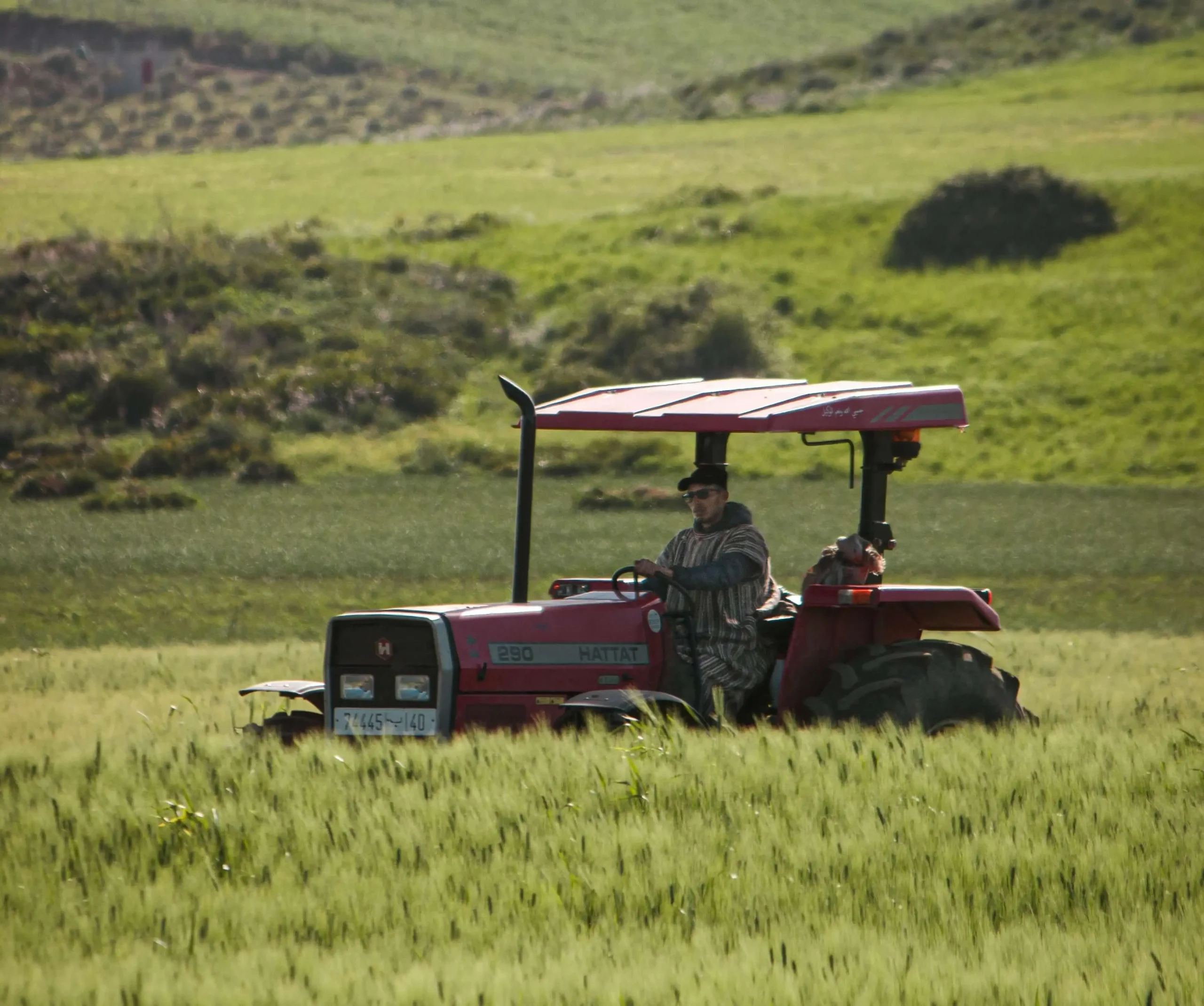 Tractor working on a large Australian farm field, representing NB Coir's bulk coco peat supply for commercial agriculture yield-boosting soil alternatives.